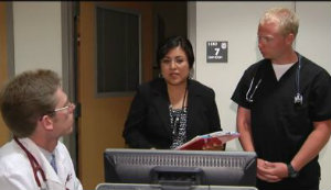 Dr. Farrell, left, consults on a patient's care transition on the video.