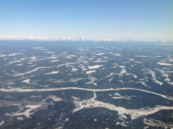Approaching Anchorage, Alaska, with glaciers in the distance.